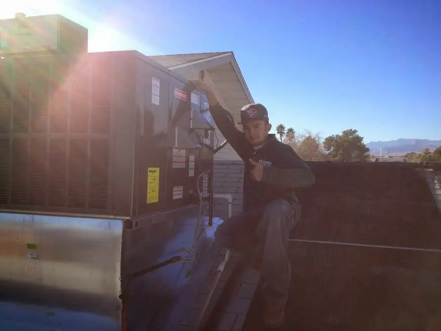 HVAC technician performing Air Duct Cleaning on a rooftop unit in Bothell West